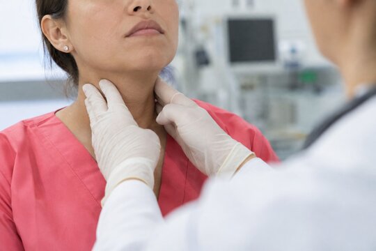 Doctor examining woman&rsquo;s neck and thyroid gland