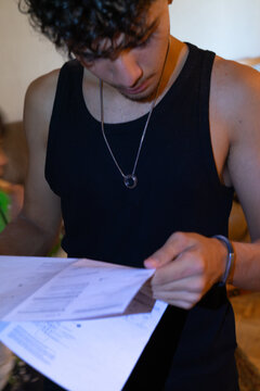 Young person attentively reading installation instructions at home