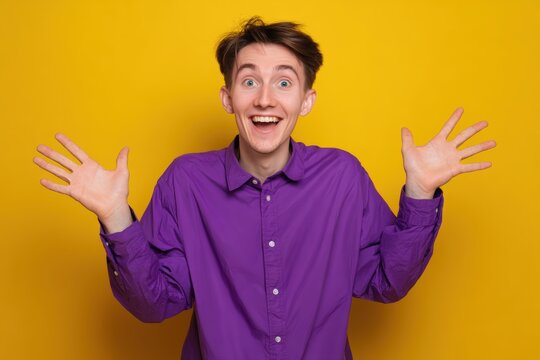 Enthusiastic young man expressing surprise against a bright yellow backdrop