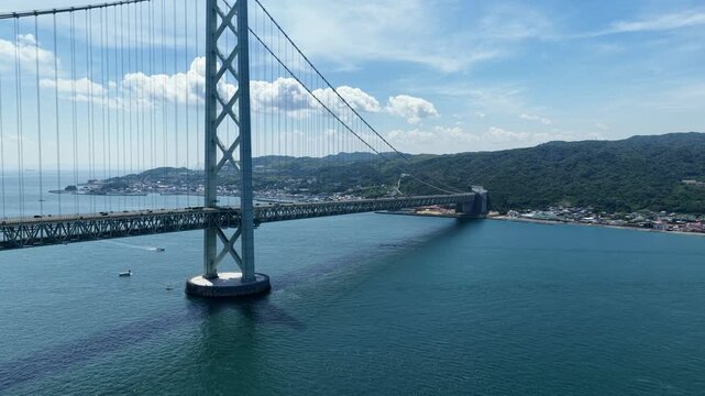 Aerial drone footage of Akashi Kaikyo Bridge over the strait in Awaji, Hyogo, Japan