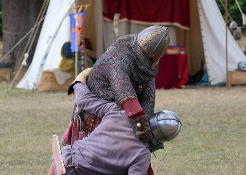 Re enactors simulating a viking vs saxon hand to hand fight 