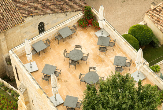 France, Bordeaux, St Emilion.  Overhead view of a restaurant's outdoor seating area with no diners.