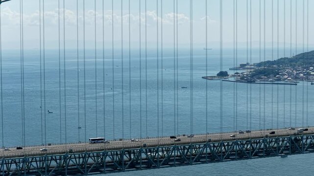 Aerial drone footage of Akashi Kaikyo Bridge over the strait in Awaji, Hyogo, Japan