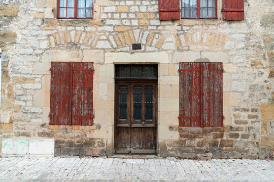 France, Lot, Bretenoux.  Architectural detail of house fa&ccedil;ade with shuttered windows.