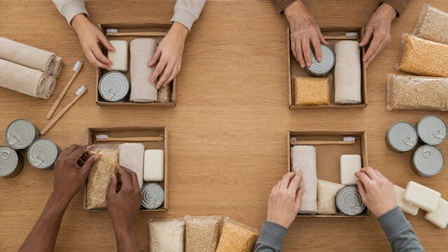 Family Hands Assemble Equal Donation Kits at Volunteer Table