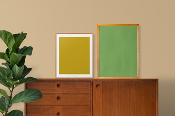 Minimal interior with framed posters, wooden cabinet, plant © Rawpixel.com
