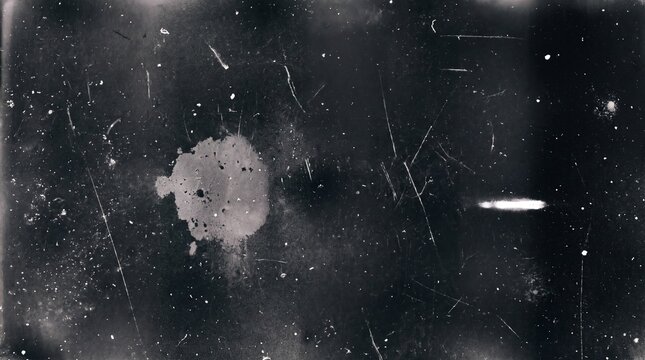 Vintage texture with dust particles, scratches, and a large white spot on dark black background
