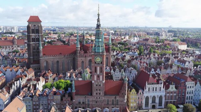 Aerial view of Main Town Hall and St. Mary's Church with historic rooftops and urban architecture in Gdansk, Pomeranian Voivodeship, Poland.