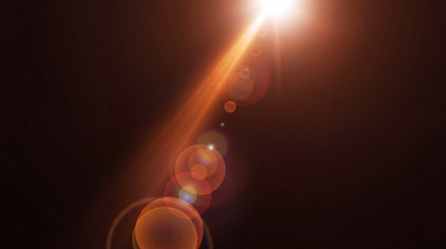 Bright orange lens flare with circular light bokeh on a dark black background overlay
