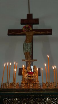 The crucifixion of Jesus Christ on the cross with candles in the church