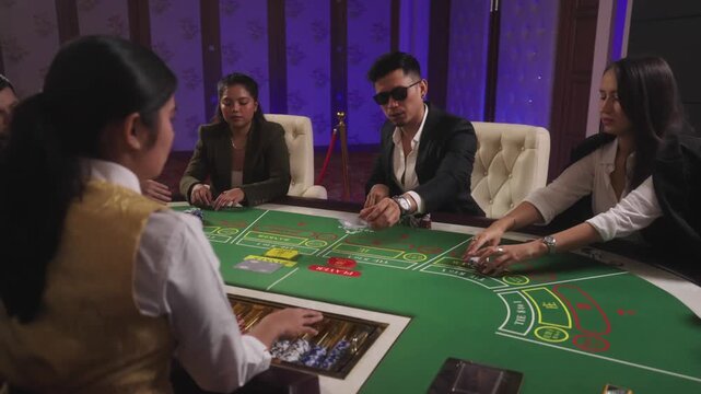 A scene where Casino players handling colored betting chips during a table game.