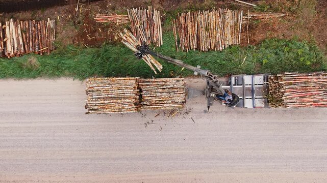 Top down slow motion shows timber loading on a gravel road in rural Latvia