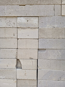 An uneven stack of white AAC (Autoclaved Aerated Concrete) blocks for a building.