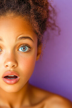 A young girl shows surprise and amazement on her face. vertical frame