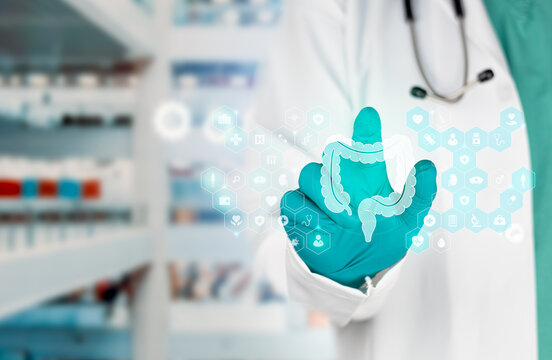 Technology in digestive health care and medical tools for the prevention of intestinal diseases. The doctor displays the symbol for the large intestine. Isolated with a bokeh background.