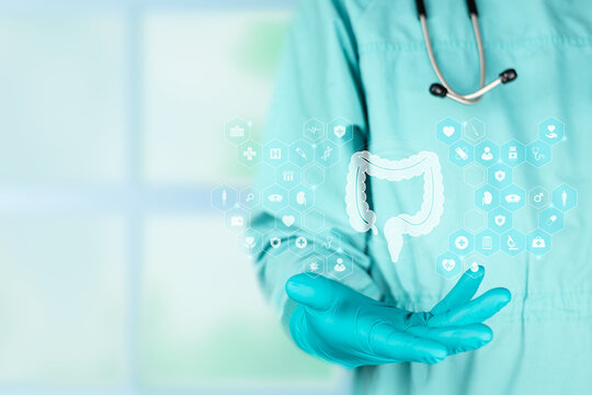 Concept of modernity in digital medicine and gastroenterology. The professional presents the silhouette of the large intestine against an emerald green background.