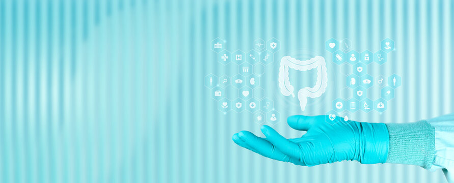 Concept of education on colon cancer and digestive health. Doctor's hand displays the icon of the large intestine, digital medicine. Emerald green background.