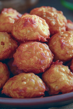 A plate filled with crispy fried tater tots, perfect for snacking or as part of a meal. vertical frame