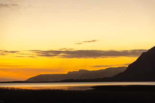 glorious sunset and dusk descending upon the Klein Mountains and Lagoon, Stanford, South Africa