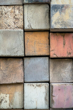 A photograph of a collection of bricks stacked together. vertical frame