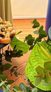 close-up of elegantly crafted, bite-sized savory appetizers arranged on a dark slate platter.