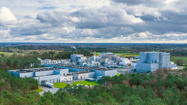 Cloudscape Over A Large Industrial Manufacturing Plant Surrounded By Rural Countryside And Open Land. Timelapse