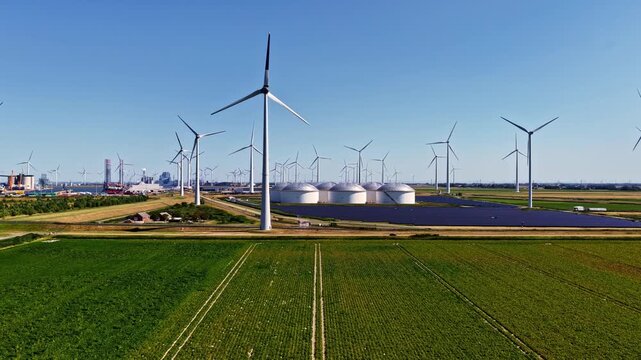 The Eemshaven Port and Industrial Energy Complex Features Wind Turbines and Energy Infrastructure Surrounded by Farmland in Groningen, Netherlands - Aerial Drone Shot