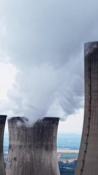 Towering Cooling Towers Release Massive Clouds of Steam Into the Sky at the RWE Kraftwerk Neurath Power Plant, Germany - Static Shot