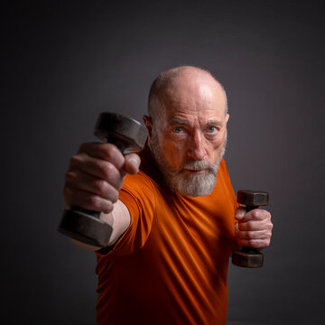 enior man exercising with dumbbells, active senior and fitness concept
