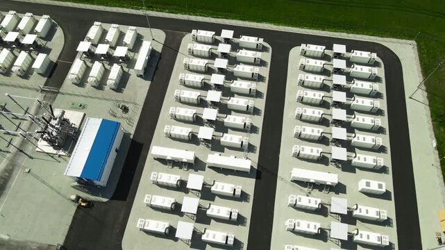 Top down aerial perspective flying over a newly built battery energy storage system, an innovative plant for storing and distributing renewable energy from wind or solar power sources
