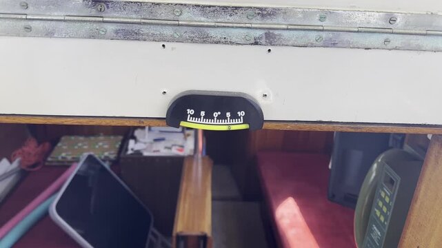 Close-up of an inclinometer on a sailboat showing the vessel heel angle while sailing, representing navigation, balance, marine equipment and sailing conditions.