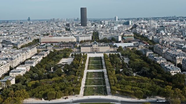 Champ de Mars lawns stretch toward &Eacute;cole Militaire as an aerial shot reveals tree-lined paths, busy roads and dense Paris housing.