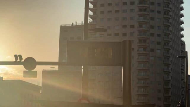 Heat haze distortion over city street with high-rise buildings at sunset, urban heatwave concept, hot summer day video footage. High quality 4k footage