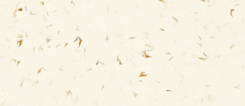 handmade paper background scattered with delicate dried golden flower petals.
