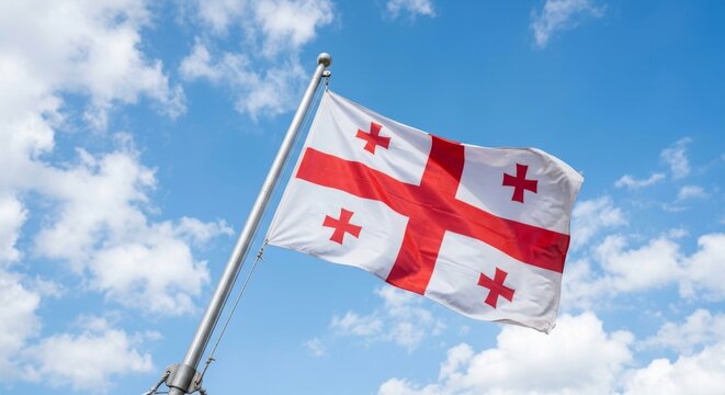 The national flag of georgia waving in the sky
