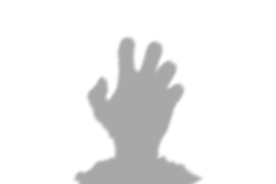A dark silhouette of a human hand reaching up from the ground representing a zombie or ghost isolated on a clear transparent
