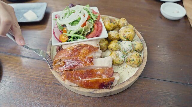 Peruvian roasted pork with crispy skin served with native potatoes 