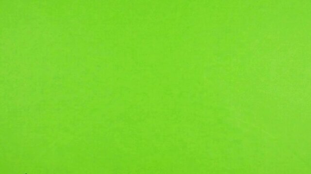 Hands holding black markers on chroma key green screen background, for creative editing, black pens