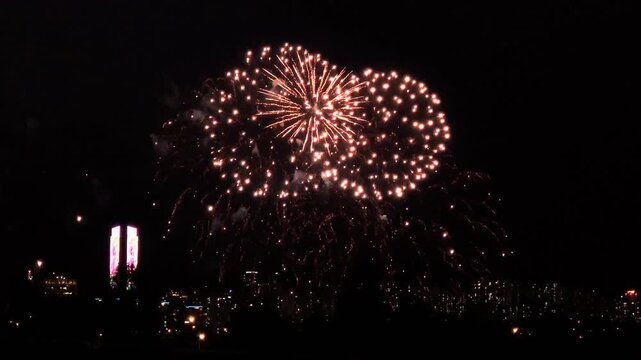 Colorful fireworks bursting over the Seoul city skyline at night, with illuminated high-rise buildings and the Han River waterfront below during an autumn fireworks festival in South Korea