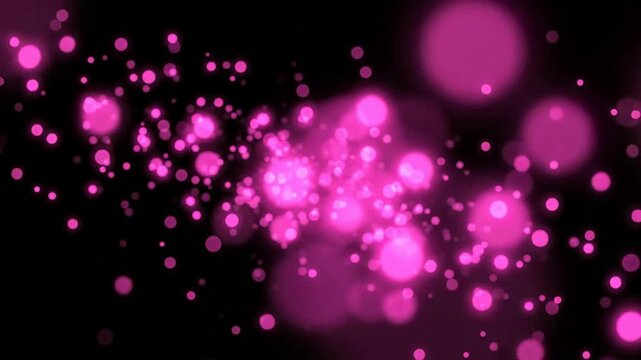 Abstract pink bokeh particles floating on black background, glowing light overlay effect
