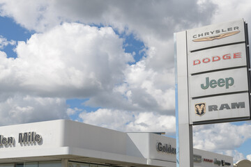 Fototapeta premium road side pylon sign of Golden Mile Chrysler Dodge Jeep Ram, a car dealer, located at 1743 Eglinton Av E, Toronto