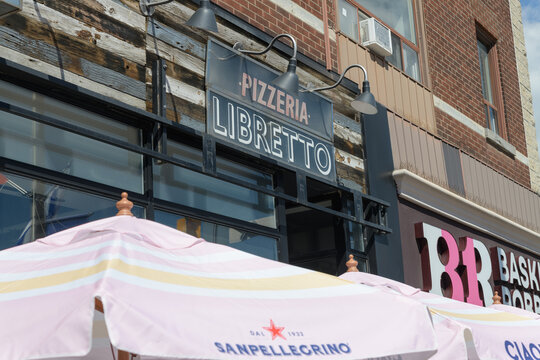 exterior building facade and sign of Pizzeria Libretto, a pizza restaurant, located at 550 Danforth Av, Toronto