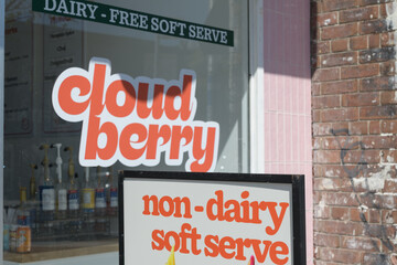 Fototapeta premium sidewalk a-frame poster sign and shop window of Cloudberry, an ice cream seller, located at 602 Danforth Av, Toronto