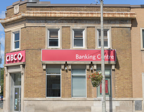 historic exterior building facade and signage of a CIBC Branch at 1586 Danforth Av at Coxwell Av, Toronto