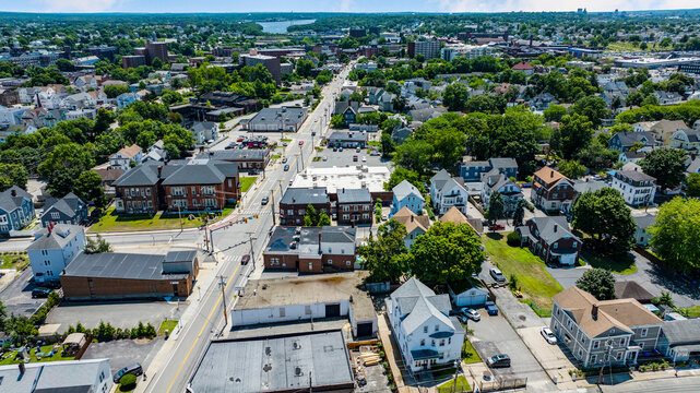 Overhead view of a suburban neighborhood featuring residential homes and commercial storefronts real estate small town urban planning residential area aerial view residential neighborhood
