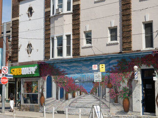 Obraz premium old apartment commercial block with mural and sign of Subway, a sandwich shop, located here at 267 Queen St W at Duncan St, Toronto