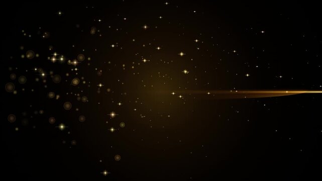 Golden glitter particles with light streak on black background