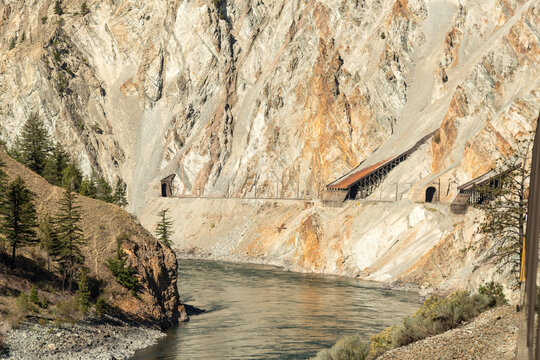 Canada, BC, Spences Bridge.  Sheds covering the railway tracks protecting them from snow and scree.  The Thompson River canyon.