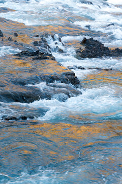 Canada, Alberta, Banff.  Dark rocks and turbulent water at the Bow River Falls.