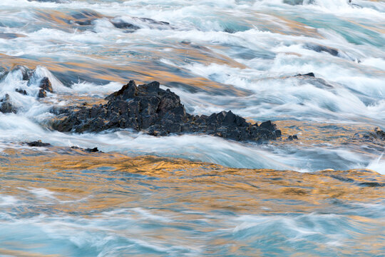 Canada, Alberta, Banff.  Dark rocks and turbulent water at the Bow River Falls.